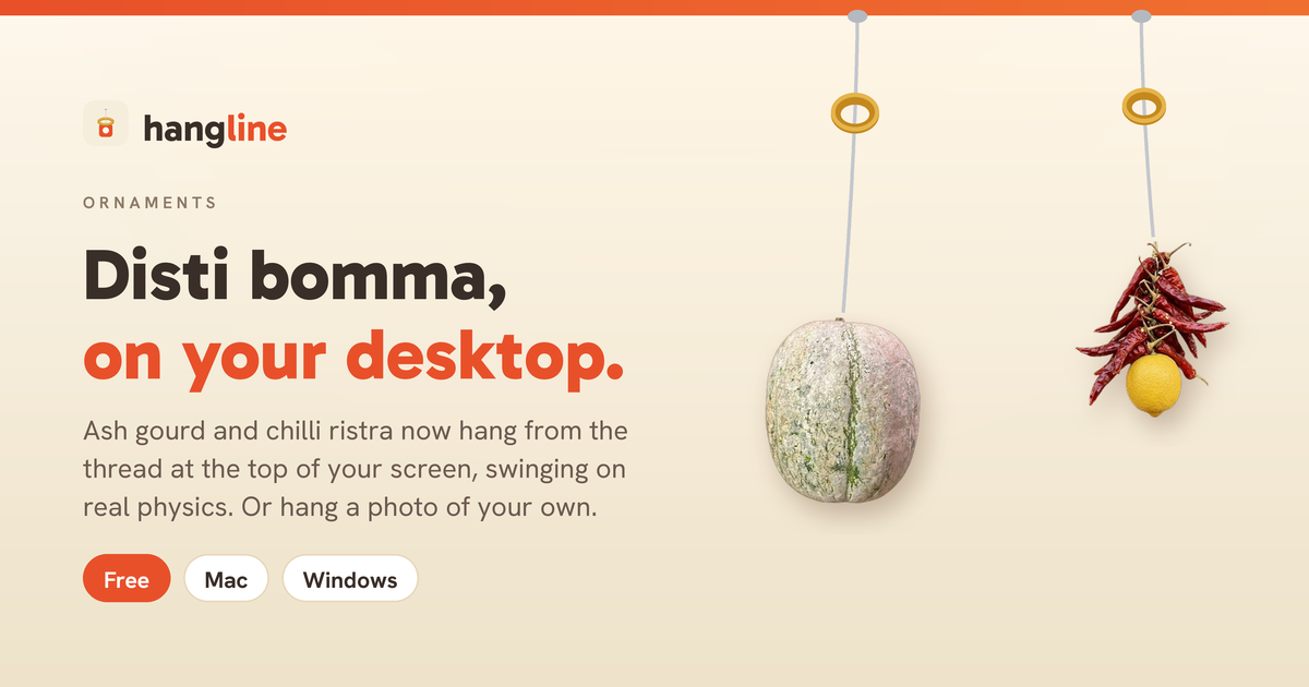Disti bomma hanging on the desktop: an ash gourd and a chilli and lemon string swinging from threads at the top of a screen